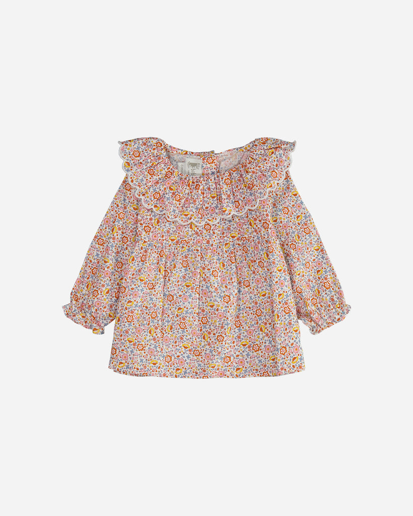 Blouse manches longues marguerite fleurs multicolores avec un col volanté.