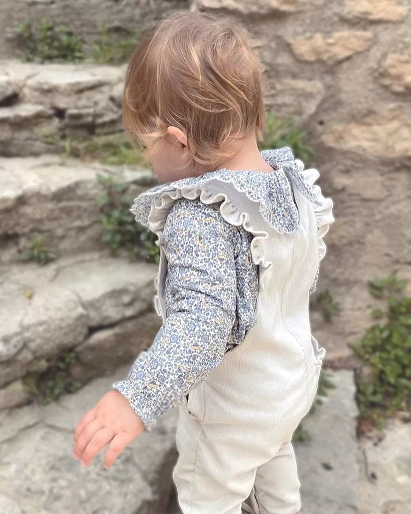 Vue du dos porté de la blouse pour bébé fille à col volanté et fleurs fleues de la marque Bobine paris.