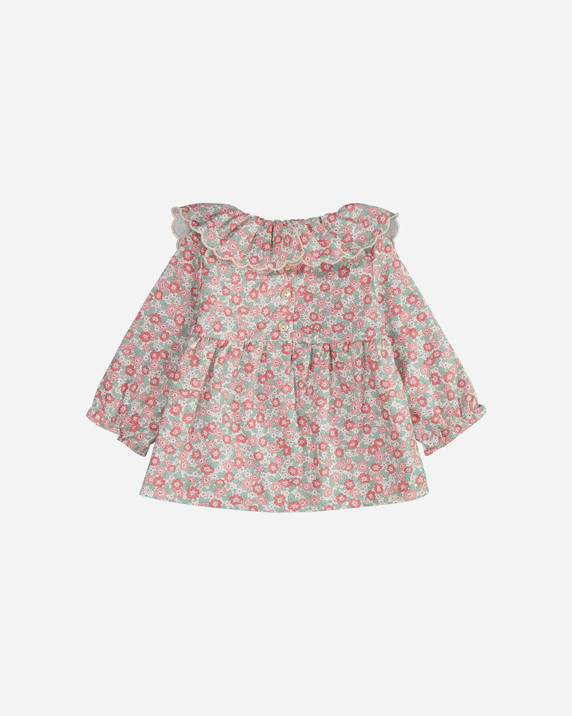 Blouse manches longues marguerite fleurs rouge et émeraude avec un col volanté vue de dos.