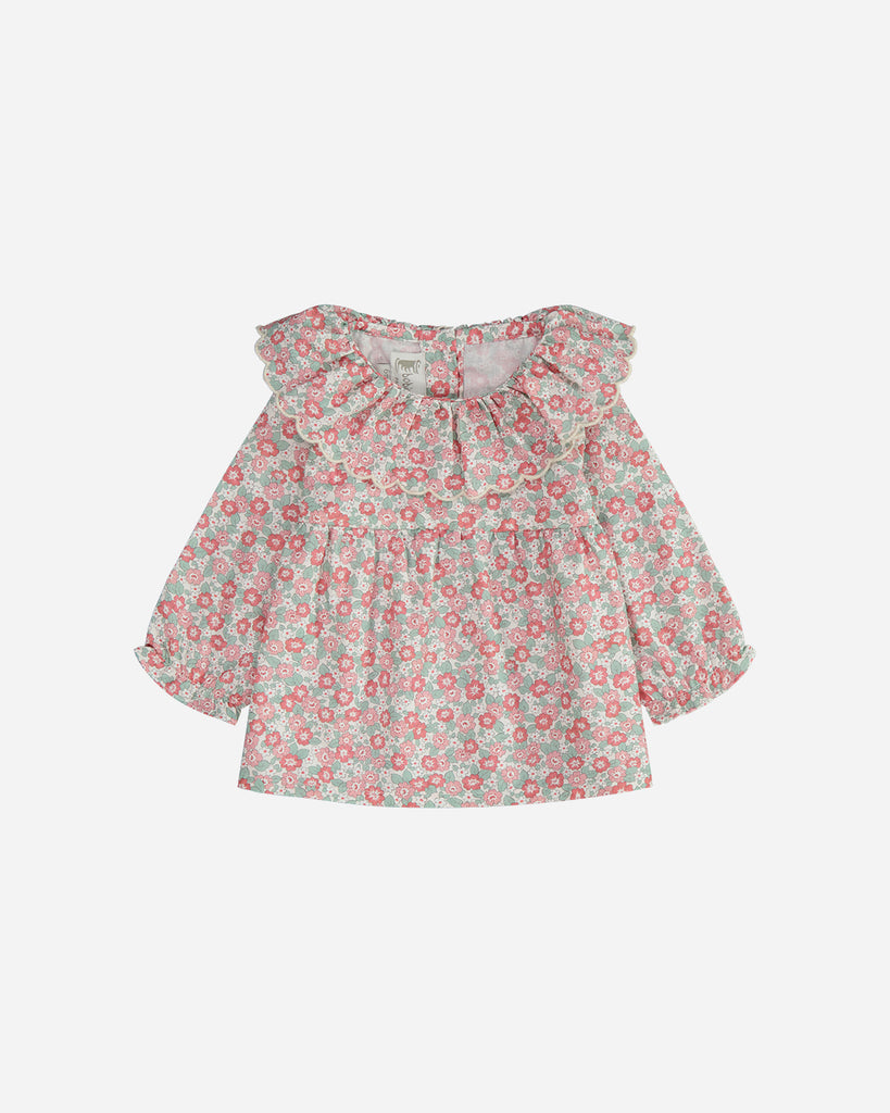 Blouse manches longues marguerite fleurs rouge et émeraude avec un col volanté.